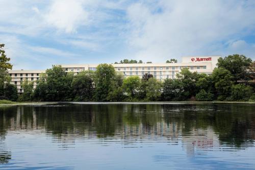 a building in front of a large body of water at Boston Marriott Newton in Newton
