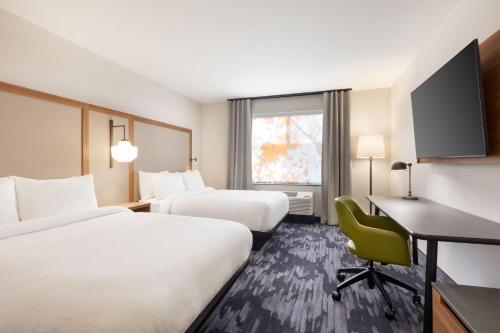 a hotel room with two beds and a desk at Fairfield by Marriott Inn & Suites Rockaway in Rockaway