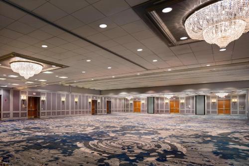 a large ballroom with chandeliers and a large room at Boston Marriott Newton in Newton