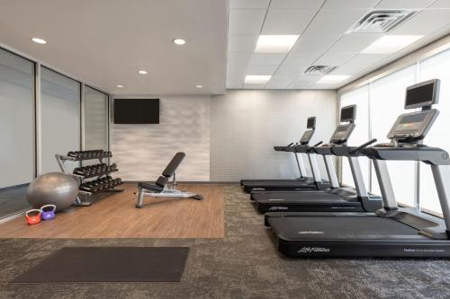 a gym with rows of treadmills and exercise machines at Fairfield by Marriott Inn & Suites Rockaway in Rockaway