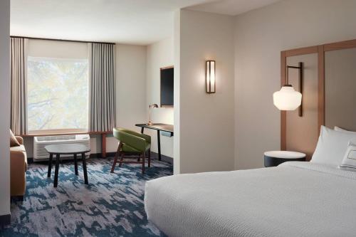 a hotel room with a bed and a desk at Fairfield by Marriott Inn & Suites Rockaway in Rockaway