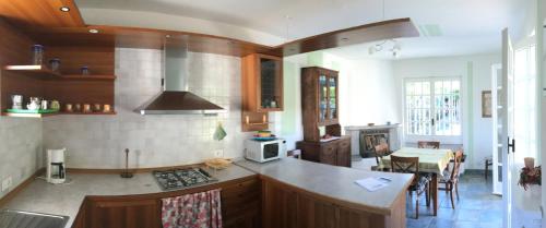 a kitchen with a counter top and a dining room at Appartamento Tennis in Cannero Riviera