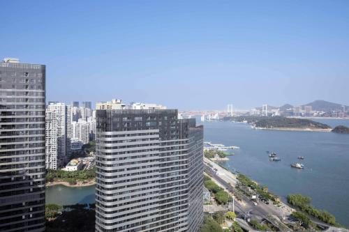 a view of a city with a river and buildings at Xiamen Marriott Hotel Haicang in Xiamen