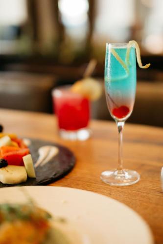a glass of wine sitting on a table with a plate of food at JW Marriott Houston Downtown in Houston