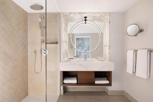 a bathroom with a sink and a shower at Sheraton Frankfurt Airport Hotel & Conference Center in Frankfurt/Main