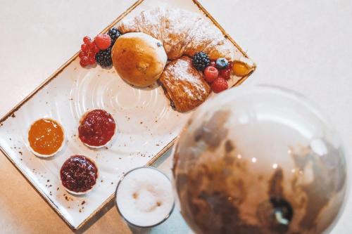 a plate of food with fruit on a table at Sheraton Frankfurt Airport Hotel & Conference Center in Frankfurt/Main