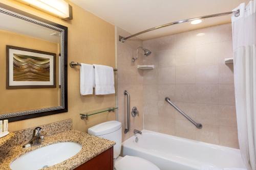 a bathroom with a sink and a tub and a toilet at Courtyard by Marriott Los Angeles Pasadena/Monrovia in Monrovia