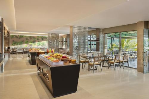 a restaurant with a buffet of food and tables at The Westin Resort & Spa Ubud, Bali in Ubud