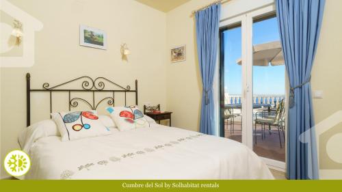 a bedroom with a bed with a view of the ocean at SolHabitat Villa Cumbre del Sol in Cumbre del Sol
