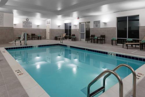 a large swimming pool with blue water at Courtyard by Marriott Indianapolis West-Speedway in Indianapolis