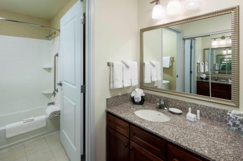 a bathroom with a sink and a large mirror at Residence Inn Houston West Energy Corridor in Houston