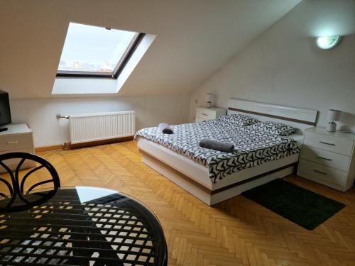 a bedroom with a bed and a window at Green Wood Apartament Stara Ochota in Warsaw