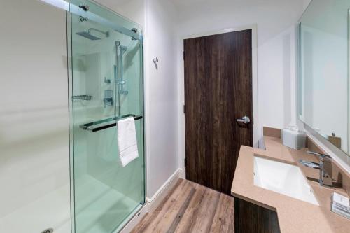 a bathroom with a glass shower and a sink at SpringHill Suites by Marriott Navarre Beach in Navarre