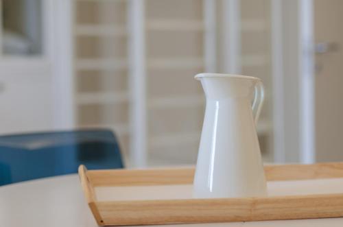 a white vase sitting on top of a table at Palazzo Junno Dimora D'Epoca in Mattinata