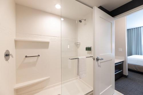 a bathroom with a shower with a glass door at Residence Inn by Marriott Fort Worth Southwest in Fort Worth