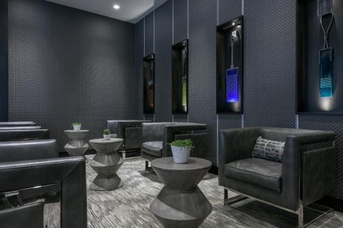 a waiting room with a chair and a barber shop at AC Hotel by Marriott Boston North in Medford