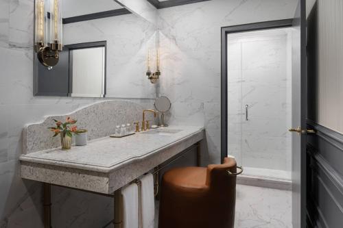 a bathroom with a sink and a mirror at The Drake Oak Brook, Autograph Collection in Oak Brook