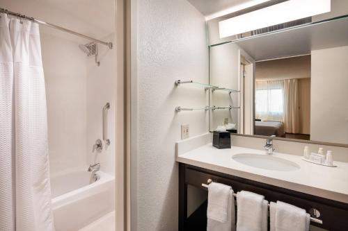 a bathroom with a sink and a mirror at Fairfield by Marriott Anaheim Resort in Anaheim