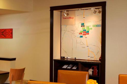 a large projection screen in a room with chairs at TownePlace Suites Houston North/Shenandoah in The Woodlands