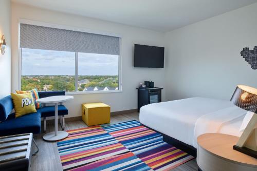 a hotel room with a bed and a window at Aloft Fort Worth Trophy Club in Trophy Club