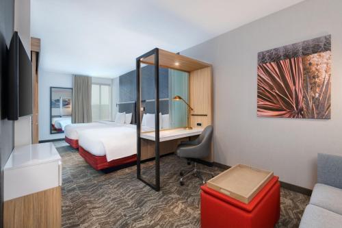 a hotel room with a bed and a desk at SpringHill Suites by Marriott Weatherford Willow Park in Willow Park