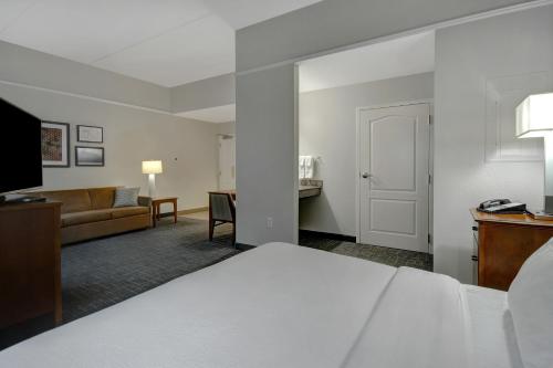 a hotel room with a bed and a living room at Residence Inn by Marriott Morgantown Medical Center Area in Morgantown