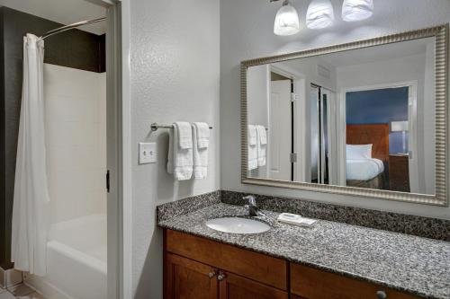 a bathroom with a sink and a mirror and a tub at Residence Inn by Marriott Morgantown Medical Center Area in Morgantown