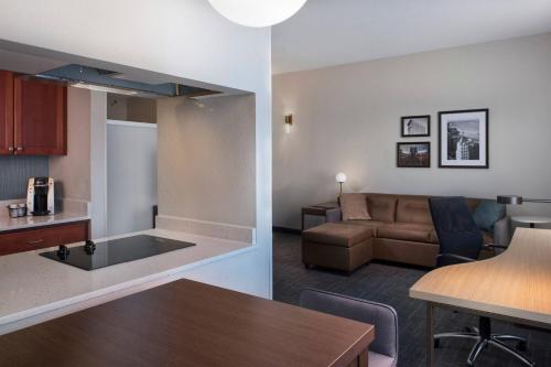 a kitchen and a living room with a couch and a table at Residence Inn Memphis Downtown in Memphis