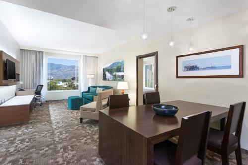 a living room with a dining table and a living room at Courtyard by Marriott Kingston, Jamaica in Kingston