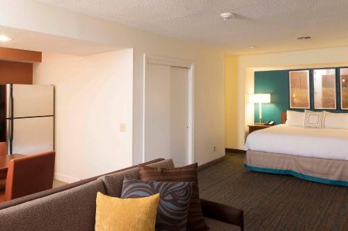 a hotel room with a bed and a couch at Residence Inn by Marriott Spartanburg in Spartanburg