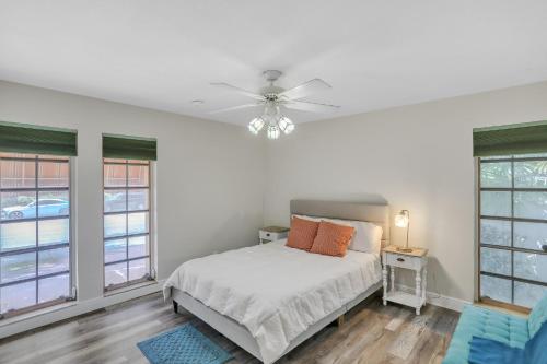 a white bedroom with a bed and windows at MiaBella of Hollywood home in Hollywood