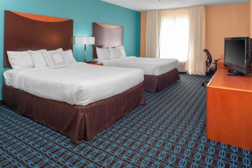 a hotel room with two beds and a television at Fairfield Inn and Suites by Marriott Seymour in Seymour
