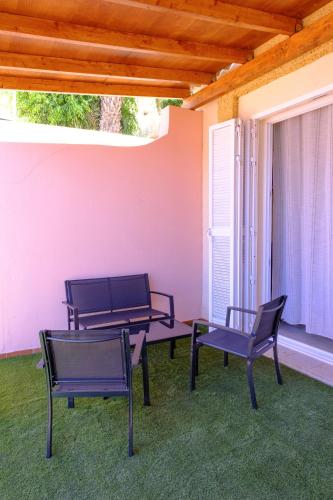 a patio with two chairs and a table and chairs at Casa del sol 2 bedrooms in Morro del Jable