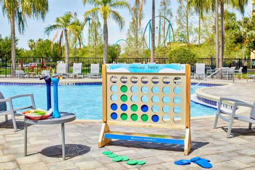 a giant abacus next to a pool at a resort at SpringHill Suites by Marriott Orlando at SeaWorld in Orlando