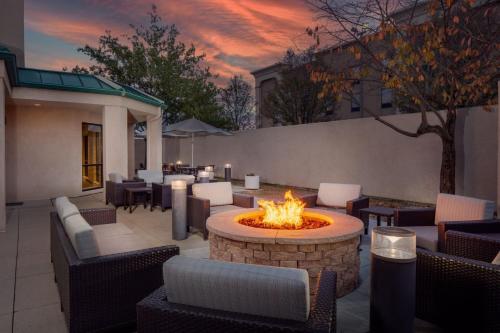 a patio with a fire pit and tables and chairs at Courtyard by Marriott Dayton North in Dayton