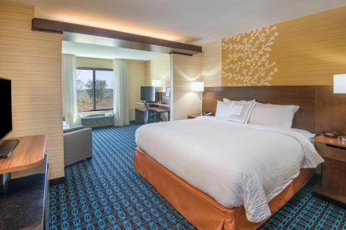 a hotel room with a large bed and a television at Fairfield Inn & Suites by Marriott Fort Wayne Southwest in Ellison