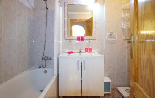 a bathroom with a sink and a tub and a toilet at Nice Apartment In Guardamar Del Segura With Kitchen in Guardamar del Segura
