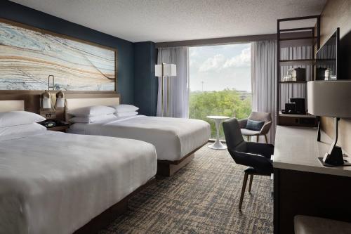 a hotel room with two beds and a window at Marriott Jacksonville in Jacksonville