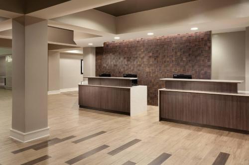 a lobby with reception desks and a brick wall at Residence Inn by Marriott Orlando at SeaWorld in Orlando