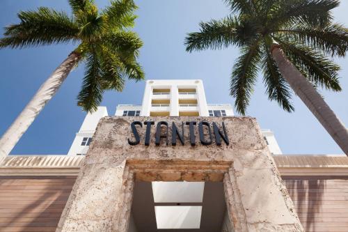 a building with a sign that reads station with two palm trees at Marriott Stanton South Beach in Miami Beach