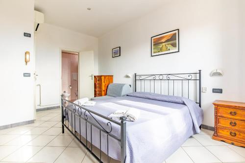 a bedroom with a bed and a dresser at Hotel Paolina in Viareggio