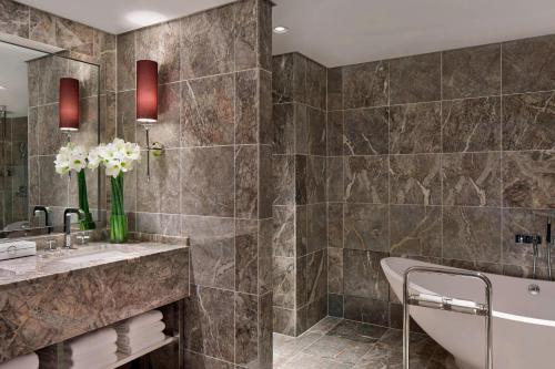 a bathroom with a tub and a sink at Tokyo Marriott Hotel in Tokyo