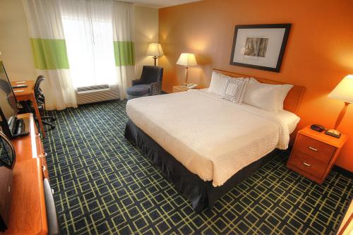 a hotel room with a large bed and a window at Fairfield Inn & Suites Mount Vernon Rend Lake in Mount Vernon