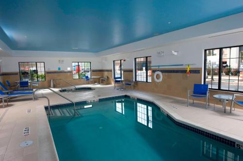 a large pool with blue water in a building at TownePlace Suites by Marriott Williamsport in Williamsport