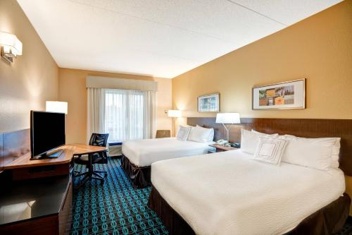 a hotel room with two beds and a desk at Fairfield Inn & Suites Christiansburg in Christiansburg