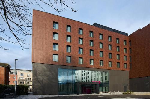 a large red brick building with a lot of windows at Moxy Chester in Chester