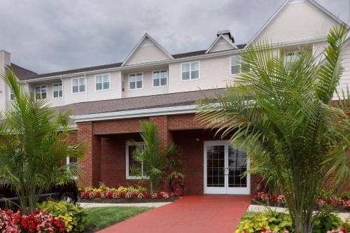 a large house with palm trees in front of it at Residence Inn Potomac Mills Woodbridge in Woodbridge