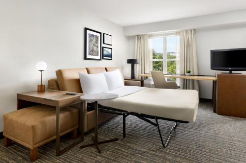 a hotel room with a couch and a table at Residence Inn Potomac Mills Woodbridge in Woodbridge
