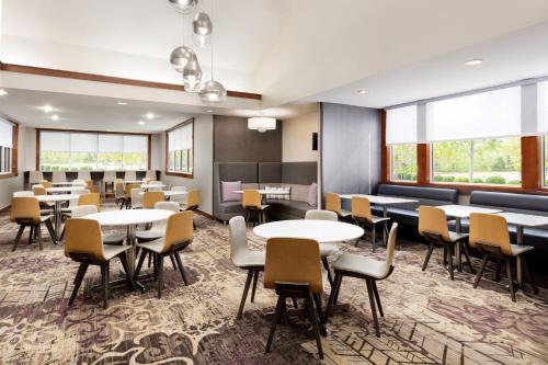 a dining room with tables and chairs and windows at Residence Inn Potomac Mills Woodbridge in Woodbridge