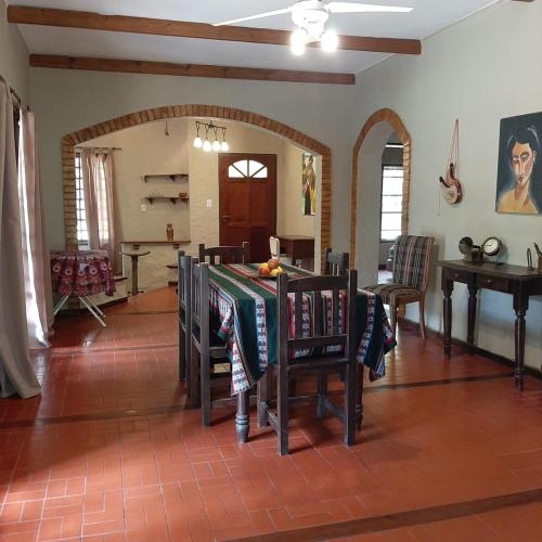 uma sala de jantar com uma mesa e cadeiras num quarto em Casa Principal - El Bamboo Eventos em Arturo SeguÃ­